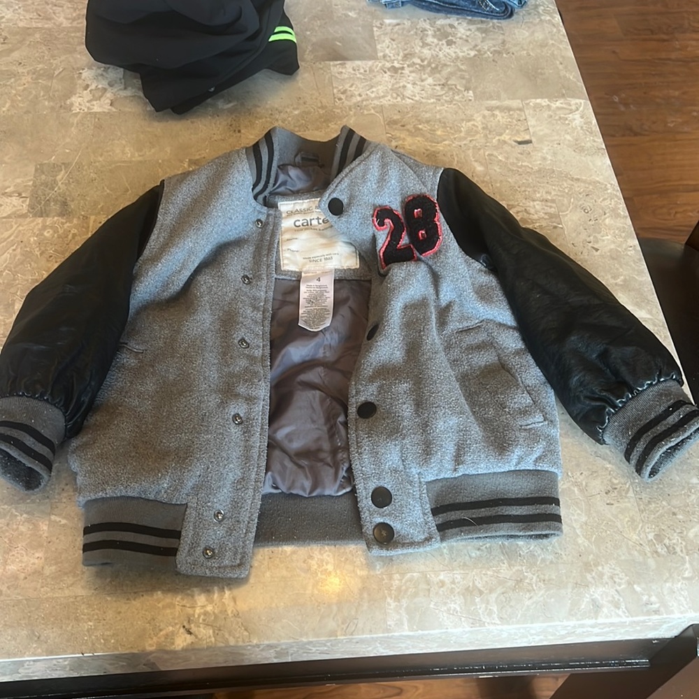 Kids varsity coat. Size 4 leather sleeves. Snap button. Pockets. Warm